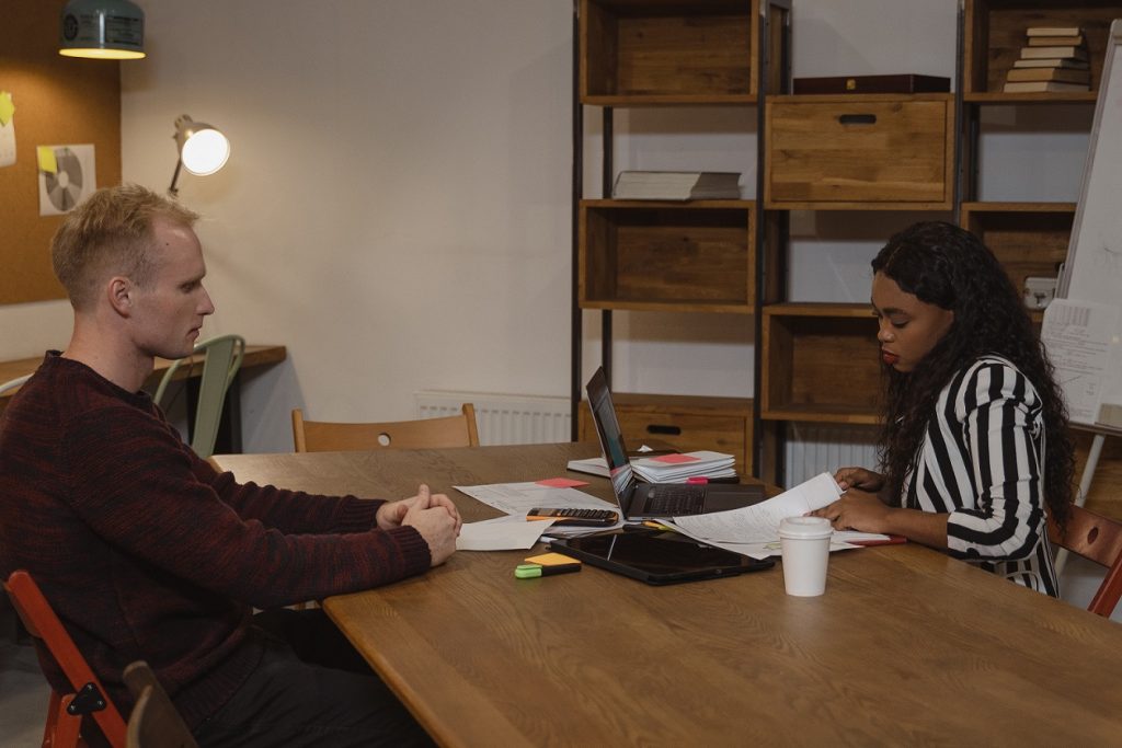 husband giving signed divorce paperwork to wife